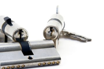 Three silver locks and its keys isolated on white ready to put in the door.